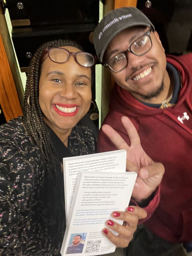 Community member with Mastra books at a meetup